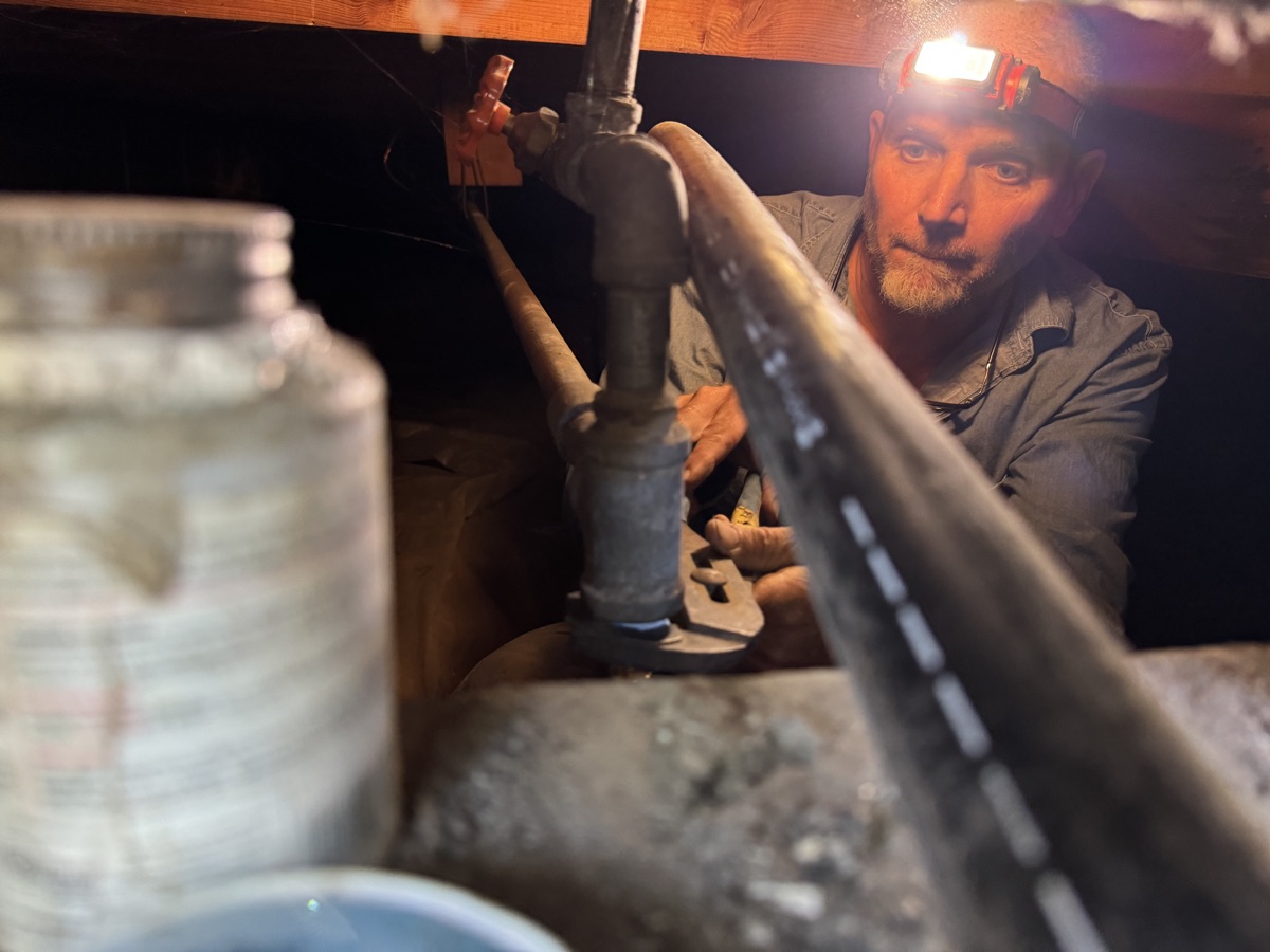 Hyde Park Plumbing technician repairing pipes in a Boise crawl space